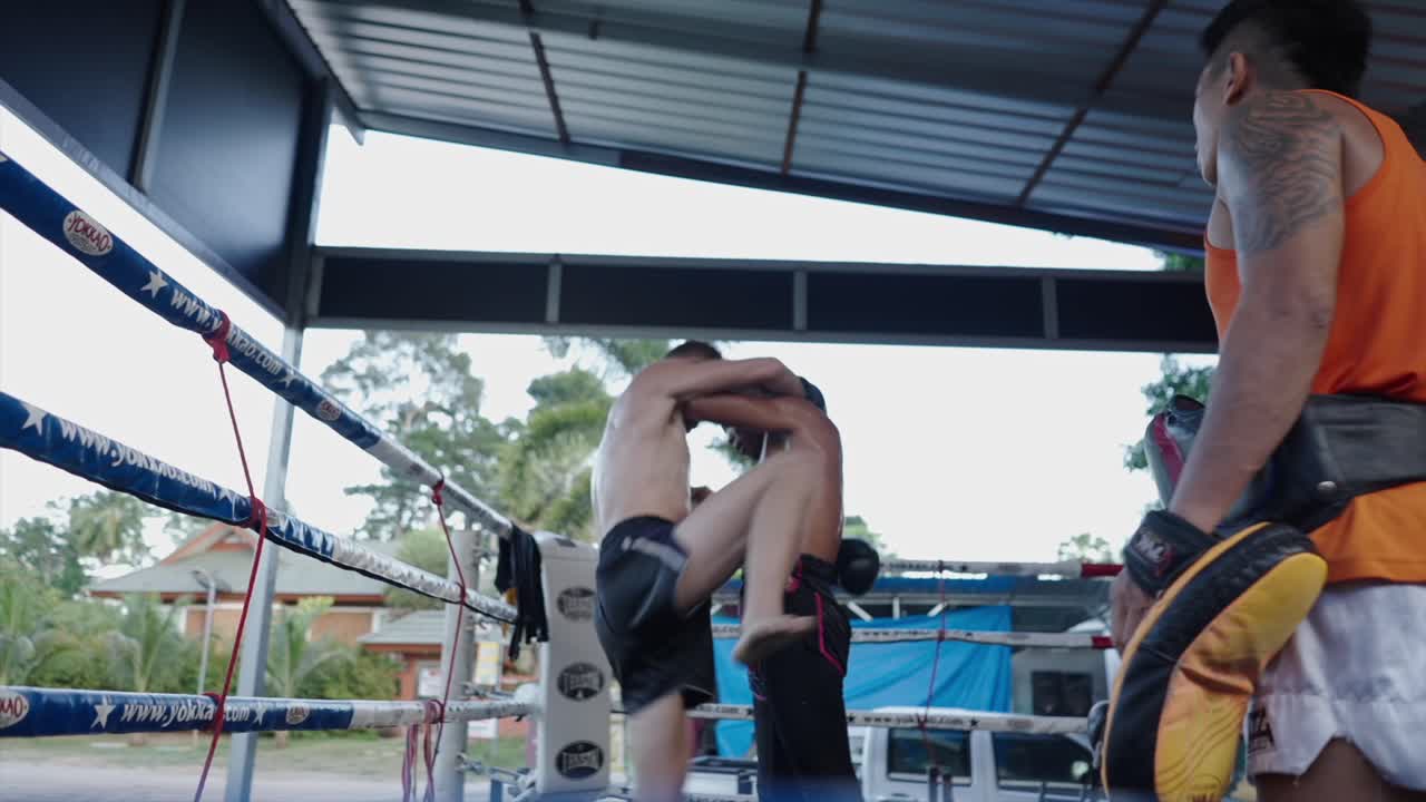 Muay Thai training session in a boxing ring