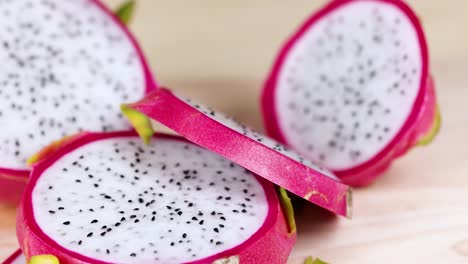 dragon fruit slices arranged on a wooden board