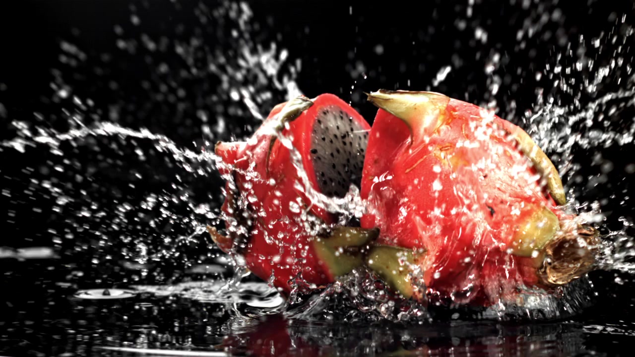 Slow Motion of Red Dragon Fruit Halves Splashing into Water