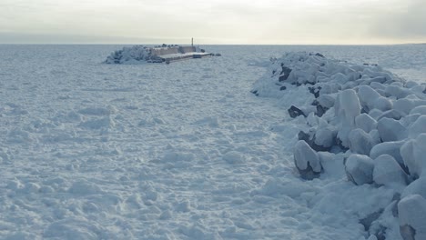 Aerial Along Frozen Covered Tetrapods Beside Drift Sea Ice At Sawaki Port, Hokkaido