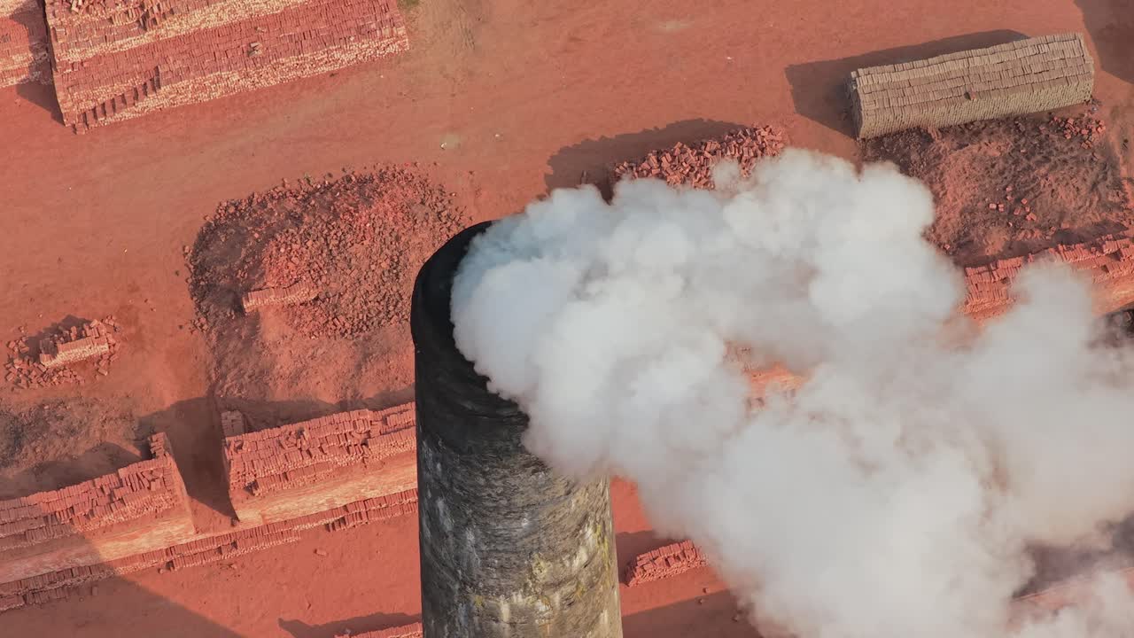Drone video of brick manufacturing factory with smoke in Bangladesh