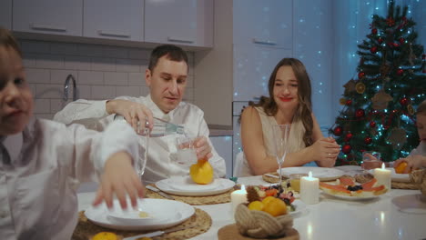 large caucasian family celebrating thanksgiving day chatting at dinner party table while eating roasted turkey and salads - celebration concept. high quality 4k footage