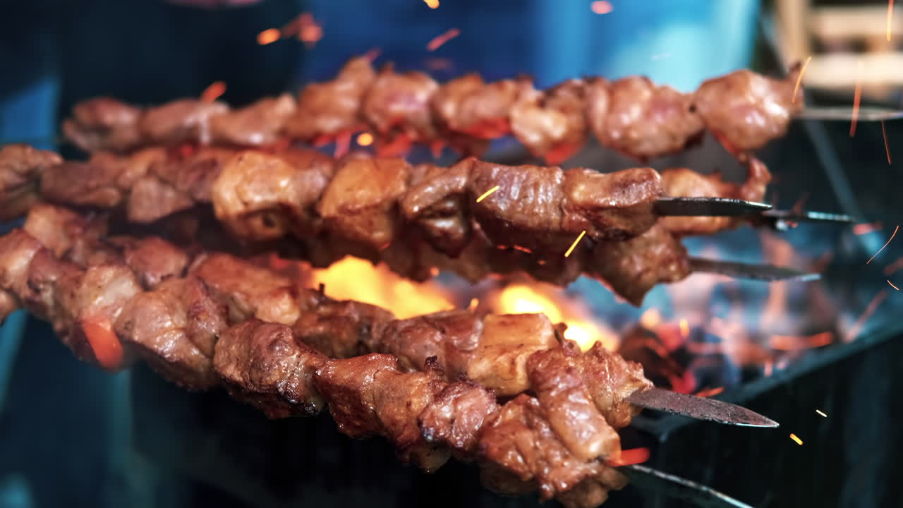 Cook making a barbecue on a grill at food festival