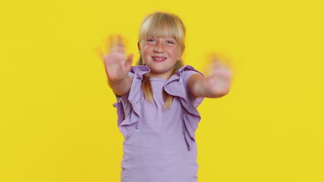 young blonde girl waving and smiling