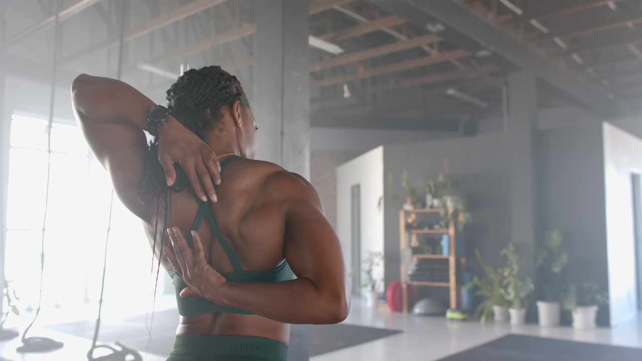Stretching in gym, strong fit woman in sportswear focusing on fitness and flexibility, copy space