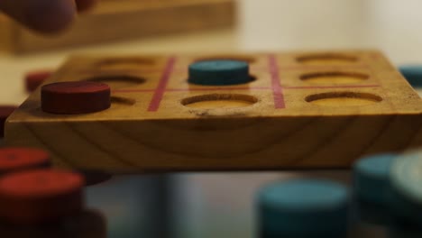 players playing tick tack toe rustic wooden hand made strategy game closeup