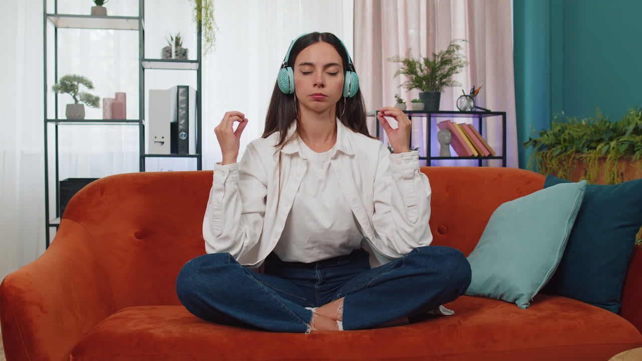 Woman breathes deeply with mudra gesture, eyes closed meditating with concentrated thoughts peaceful