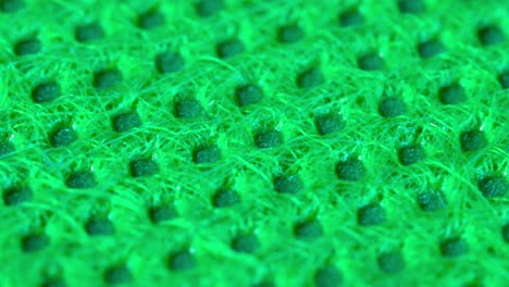 Green-textile-cloth-surface-texture,-macro-shot-close-up-view-with-rotation-motion