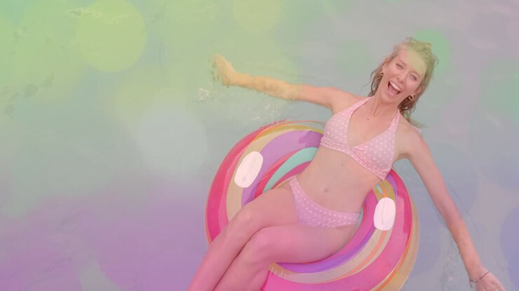 Smiling woman relaxing on colorful float in pool over bokeh lights animation