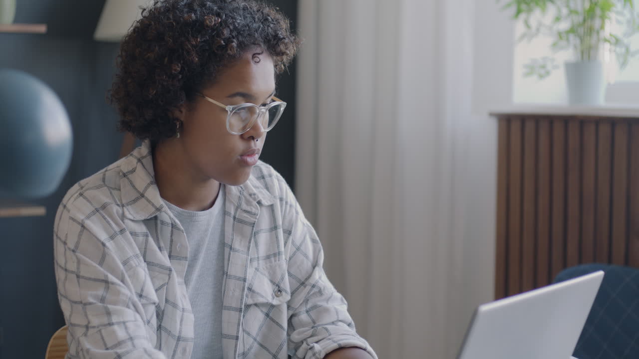 Woman working on laptop at home