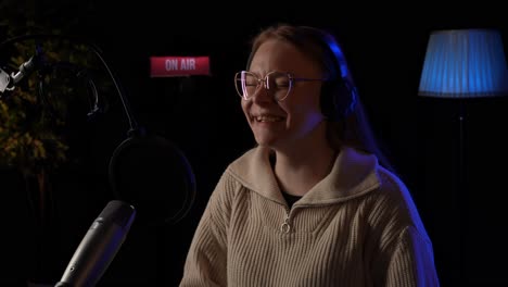 woman recording podcast in studio