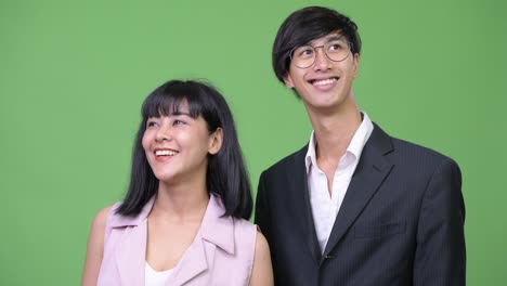 young happy asian business couple thinking together