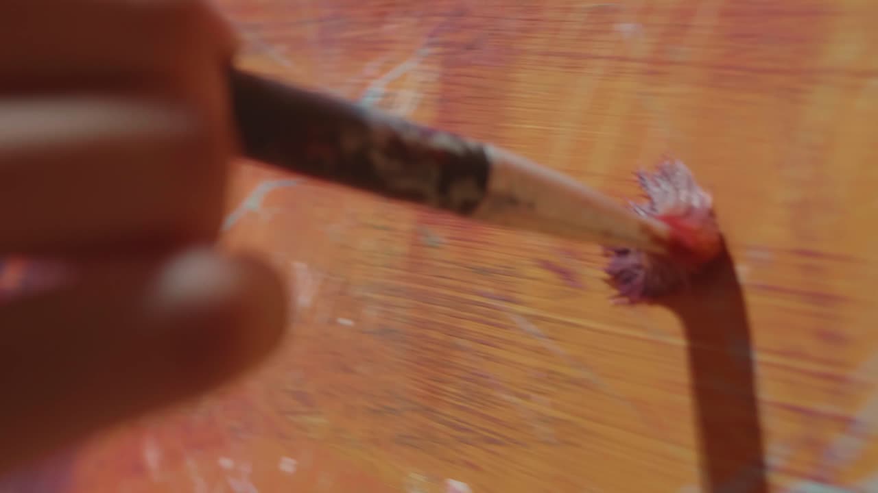 Asian Male Artist Works On Abstract Painting, Moving Paint Brush Energetically He Creates Modern Masterpiece