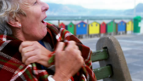 Senior-couple-hugging-each-other-at-the-beach