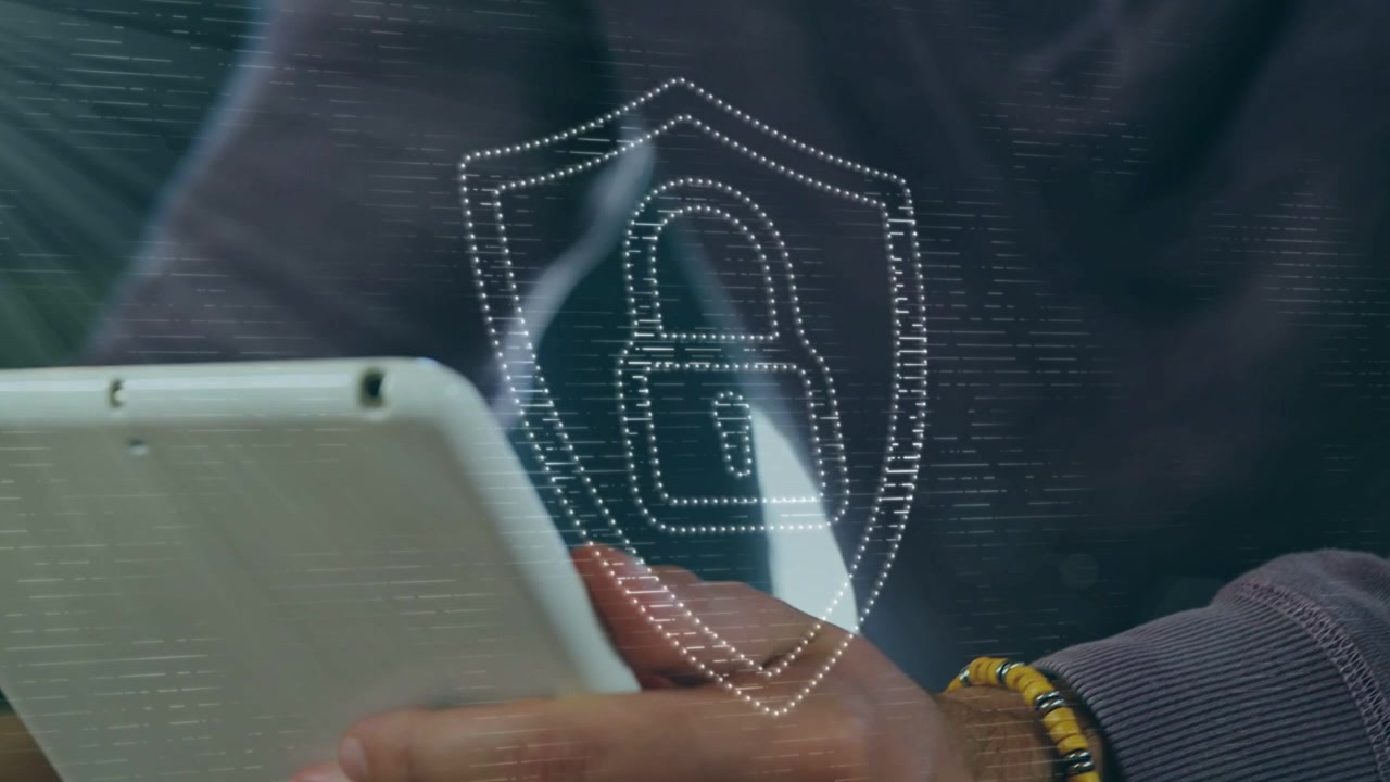 Man tapping tablet in cafe, activating hologram shield padlock centering over device for security