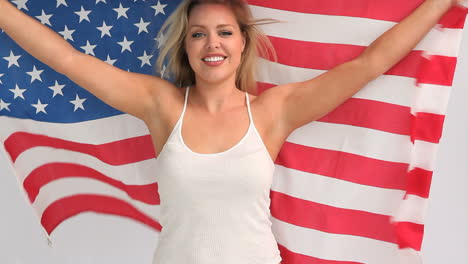 blonde woman holding a usa flag