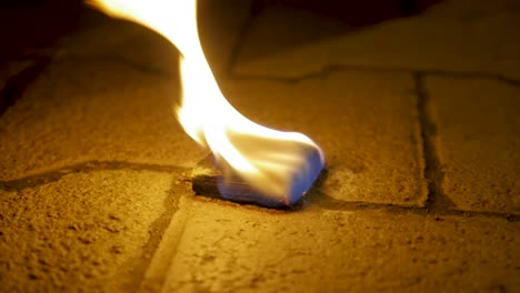 burning object on a stone surface at night