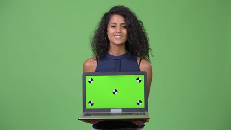 young beautiful hispanic businesswoman showing laptop
