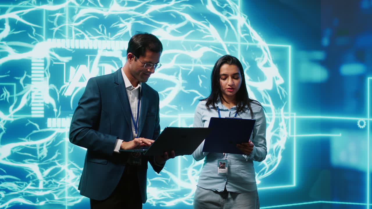 Computer scientists collaborating on developing AI system in high tech workspace