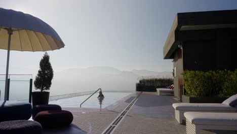 slim asian woman relaxing at luxury infinity pool of hotel indigo alishan in taiwan