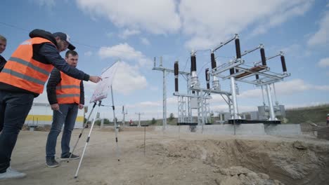 engineers supervise the construction of a transformer substation