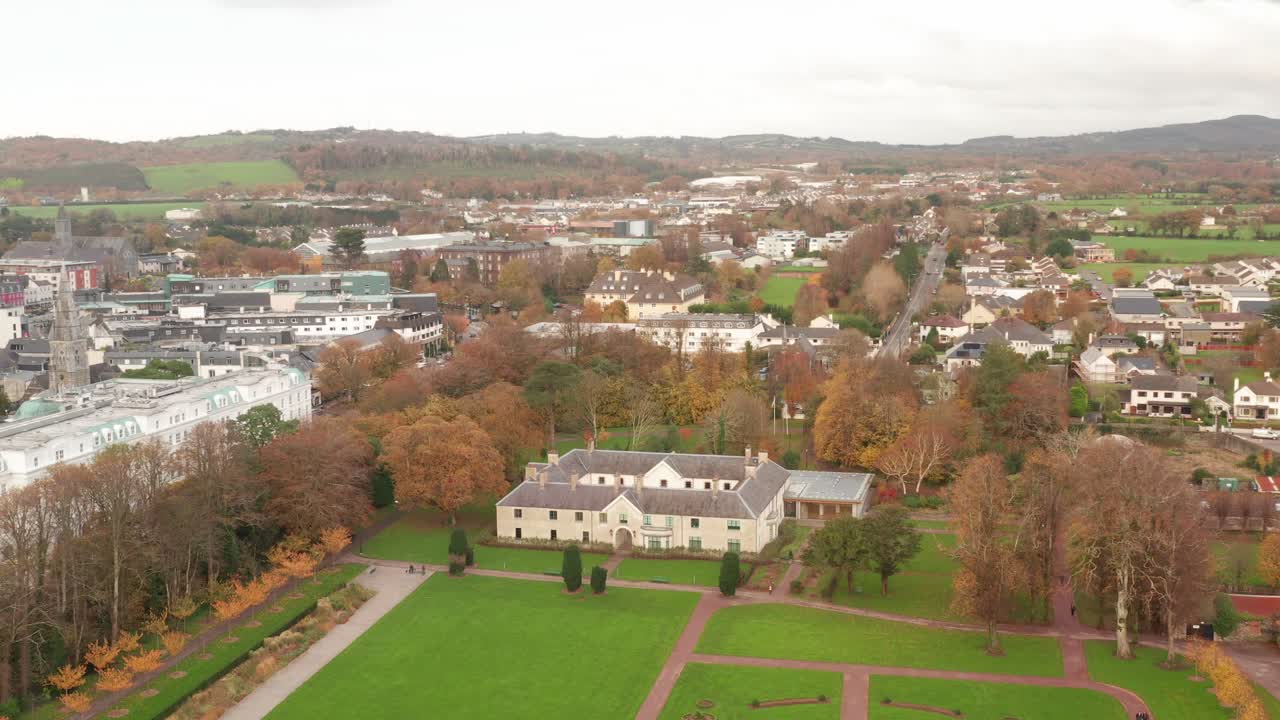 Aerial paralax shot of Killarney House and Gardens in Killarney, Ireland in the fall