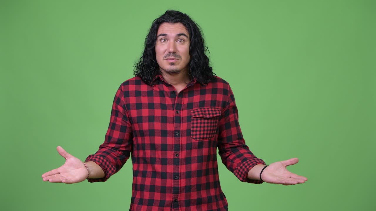 Handsome hipster man shrugging shoulders