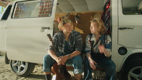 Young-Tourists-Sitting-in-Van-and-Chatting