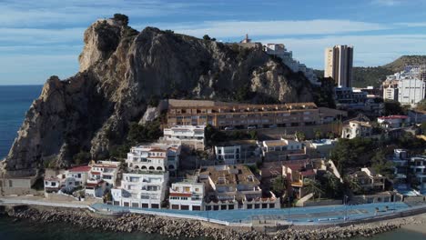 aerial footage of the older part of benidorm with the smaller houses at the foot of the rock in the province of alicante in spain