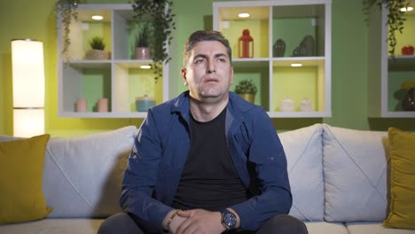 unhappy, depressed man is thoughtful and not feeling well at home.