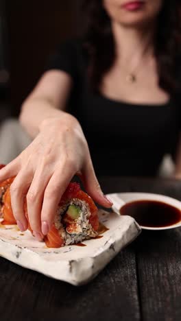 woman eating sushi