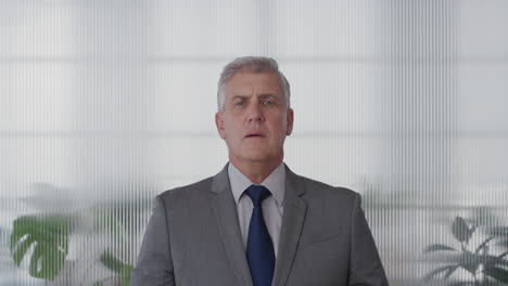 portrait handsome mature businessman executive preparing for meeting checking tie looking confident serious corporate professional in office slow motion