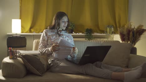 male student studying at night in laptop light.