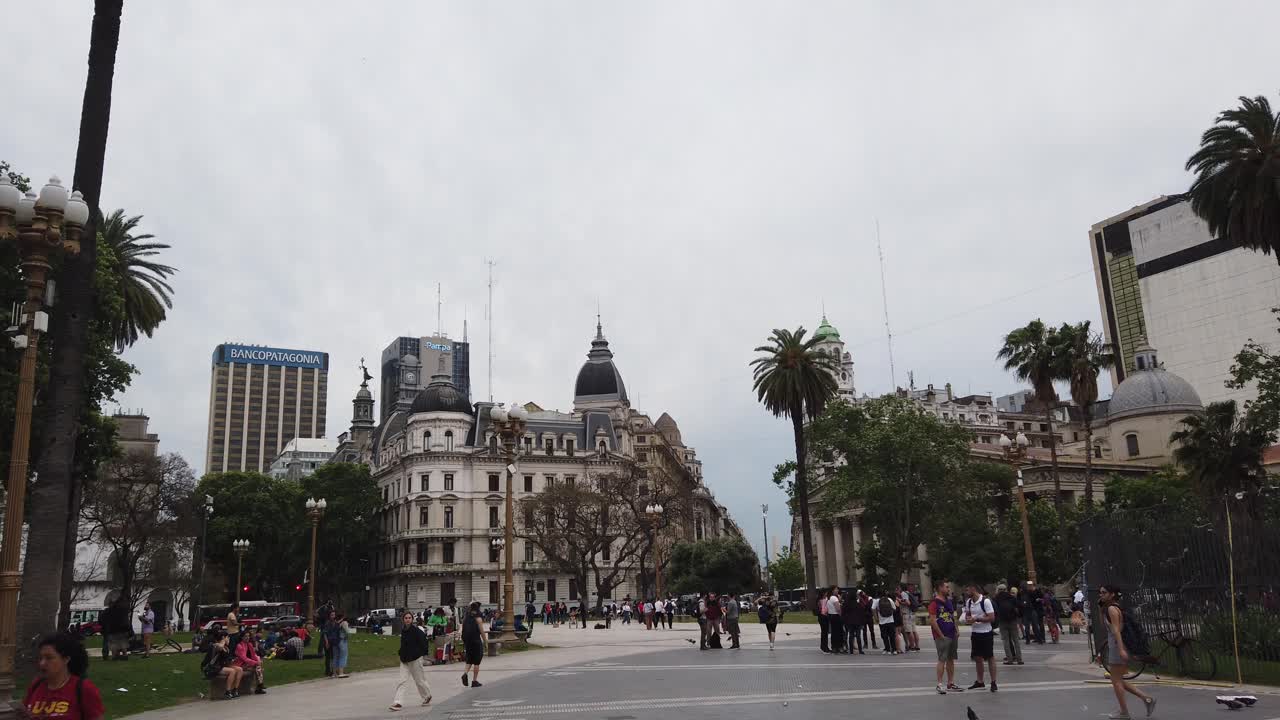 Panning view at Plaza de Mayo Urban Park Landmark of Historic City, local People walking by