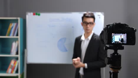 asian business coach recording video at home