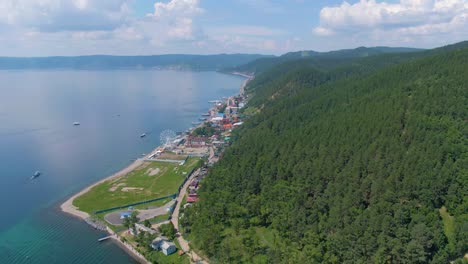 aerial view of lakeside town with lush forest