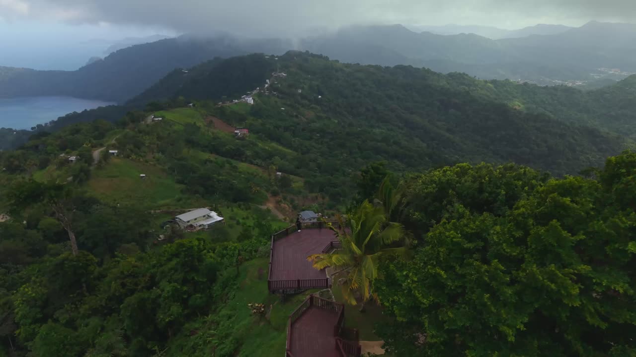 Aerial view of a young Latina pauses her journey to soak in the stunning, high-altitude vista at La Vigie Lookout