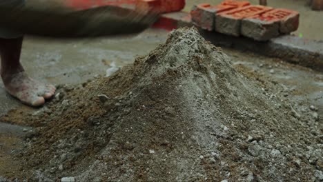 construction site mixing cement for building barefoot indian labor