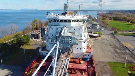 aerial of great lakes ore bulk lake freighter carrier while passing through locks on the northern great lakes