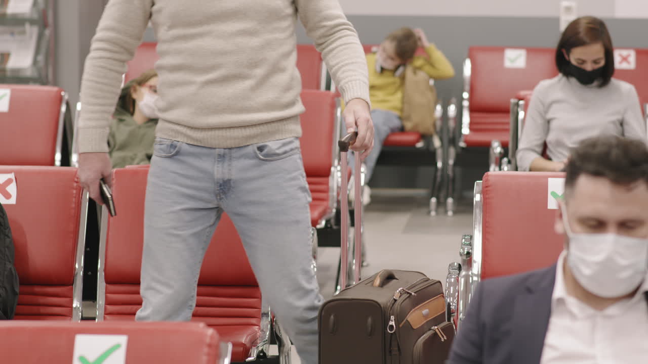 Man Taking Seat In Departure Lounge