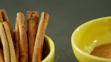 cinnamon sticks and powder in bowl 4k