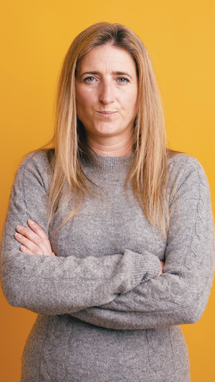 Serious Woman with Arms Crossed Looking at Camera