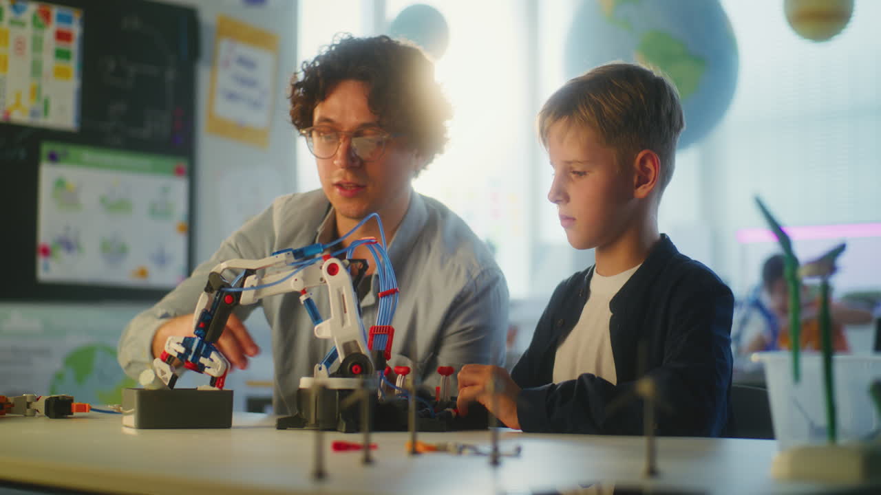 Teacher and Student Working on a Robot Project in Classroom