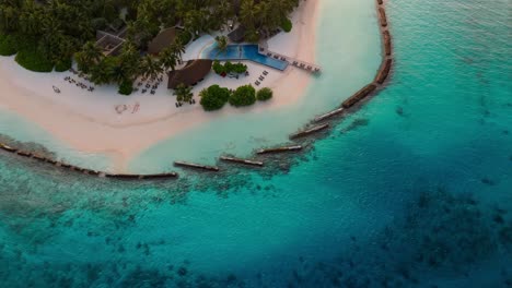a breathtaking aerial drone view captures rasdhoo island bathed in the warm glow of sunset in the maldives.