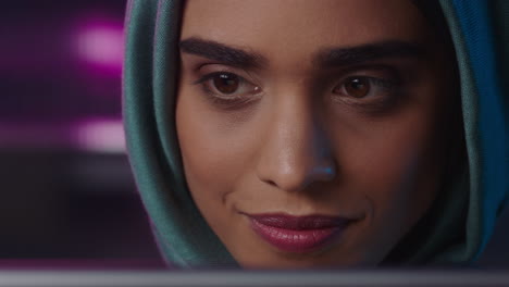 close-up-portrait-beautiful-muslim-business-woman-using-tablet-computer-working-late-browsing-internet-brainstorming-looking-at-information-on-screen-wearing-headscarf