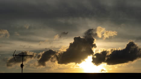 beautiful golden yellow dramatic sunset cloudy windy sky setting sun clouds timelapse with antenna and roof foreground