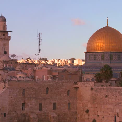 a timelapse shot of clouds moving behind the dome of the rock in the old city of jerusalem