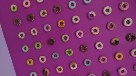 rotating shot of a colorful glazed donut wall