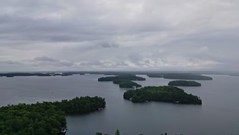 Islands-With-Shoreline-Cottages-Against-Cloudy-Sky-In-Lake-Rosseau,-Ontario,-Canada