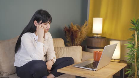 woman watching movie on laptop at night at home.